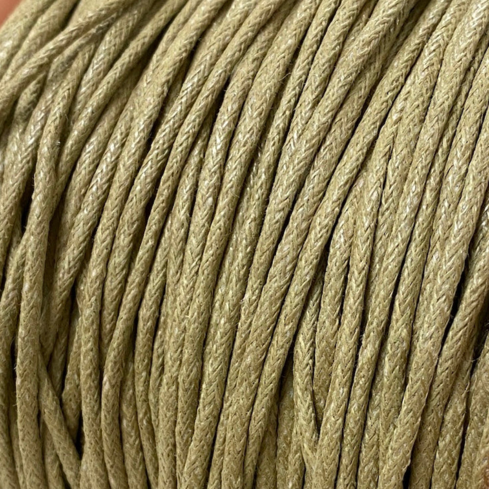 A spool of natural beige colour wax cotton cord used for crafting and jewelry making.