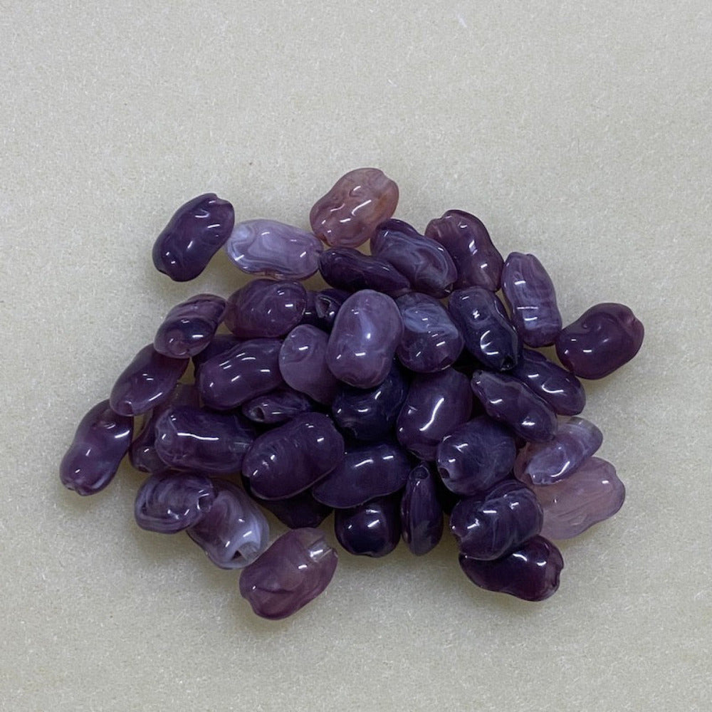 Amethyst purple gemstone style acrylic beads resembling real gemstones, with visible threading holes for crafting jewelry on a white background, used for crafting and jewelry making.