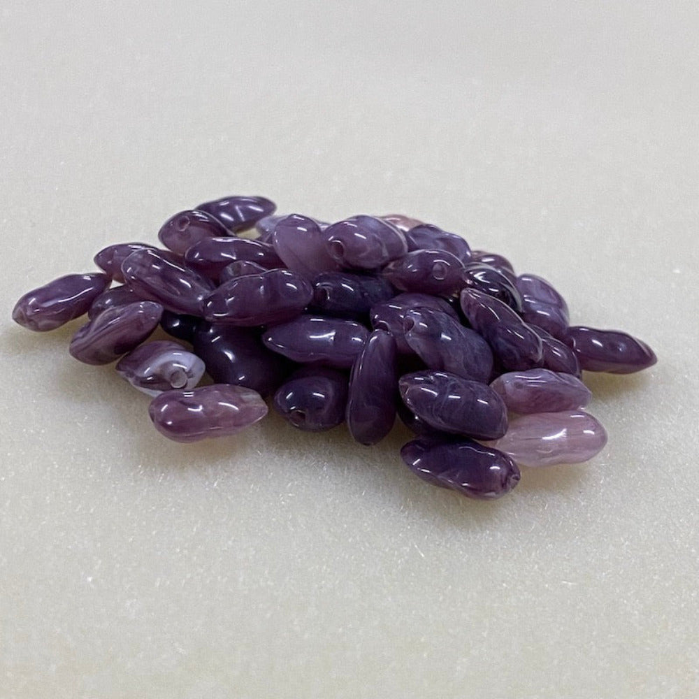 Amethyst purple gemstone style acrylic beads resembling real gemstones, with visible threading holes for crafting jewelry on a white background, used for crafting and jewelry making.