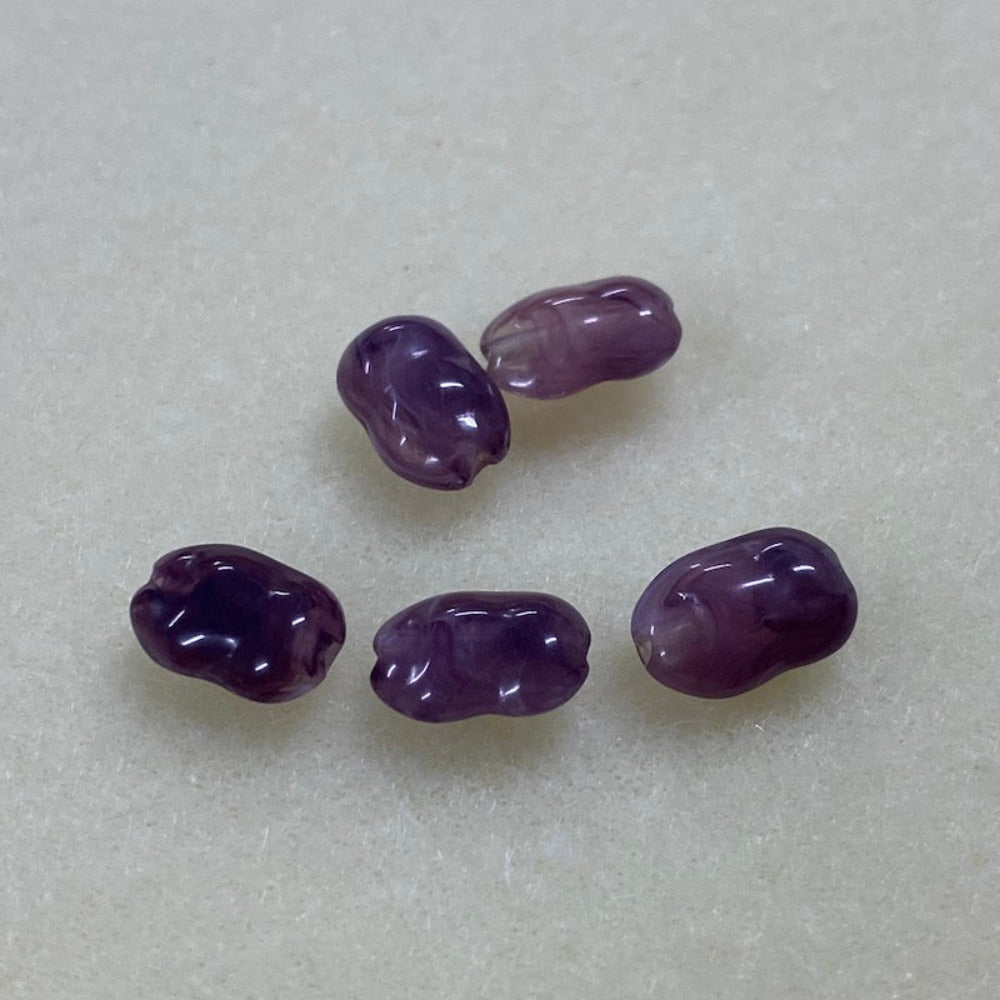 Amethyst purple gemstone style acrylic beads resembling real gemstones, with visible threading holes for crafting jewelry on a white background, used for crafting and jewelry making.