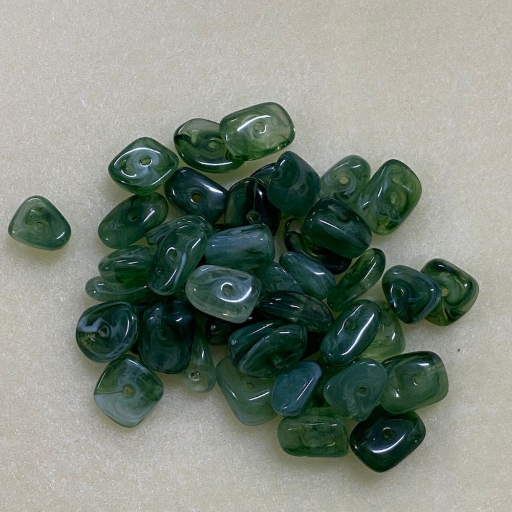 Jade green gemstone style acrylic beads with visible threading holes for crafting jewelry on a white background