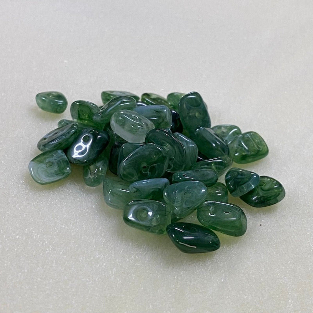 Jade green gemstone style acrylic beads with visible threading holes for crafting jewelry on a white background