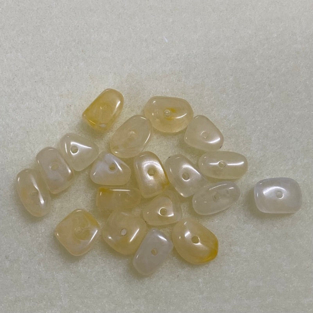 Citrine yellow gemstone style acrylic beads resembling real gemstones, with visible threading holes for crafting jewelry on a white background, used for crafting and jewelry making.