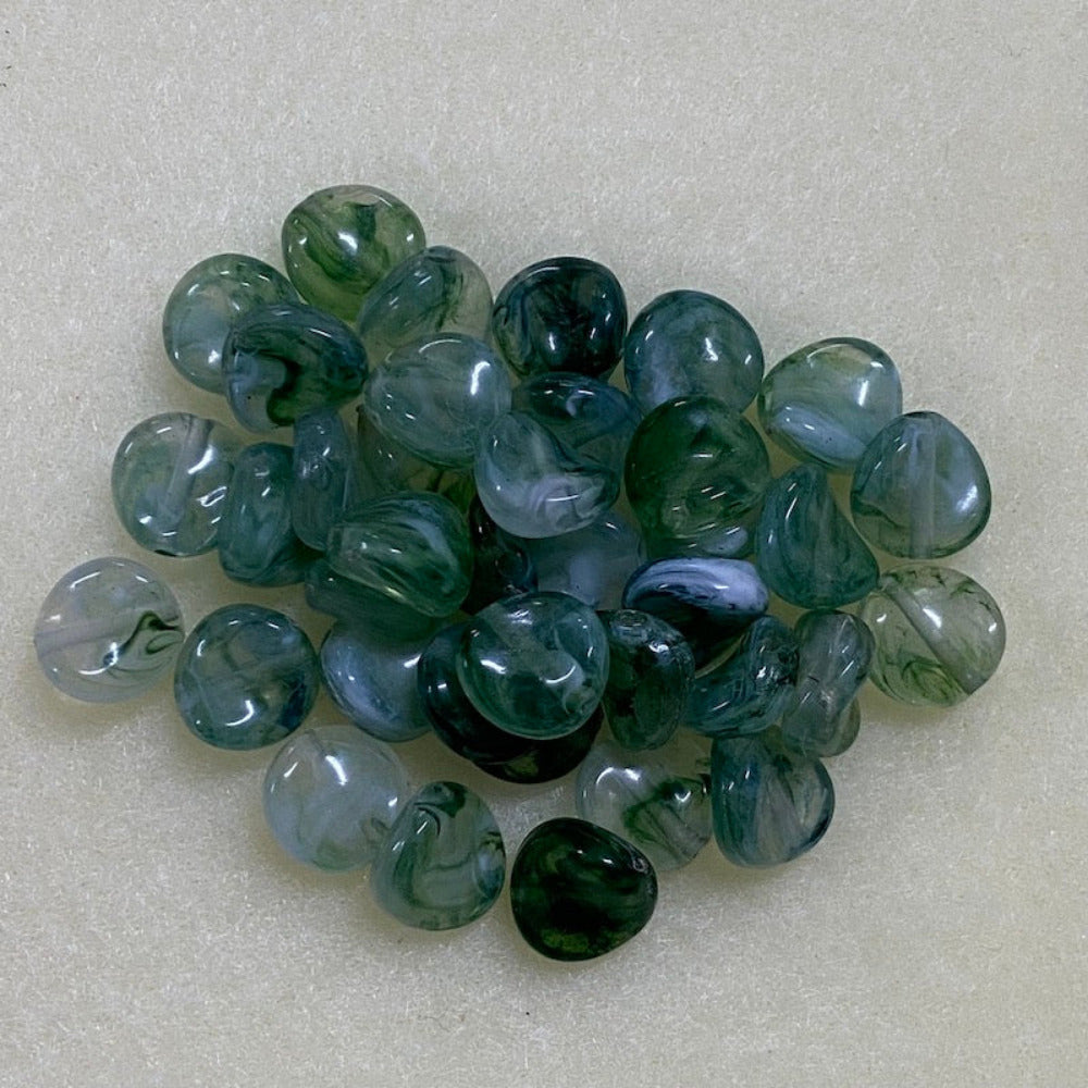 Jade green gemstone style acrylic beads with visible threading holes for crafting jewelry on a white background