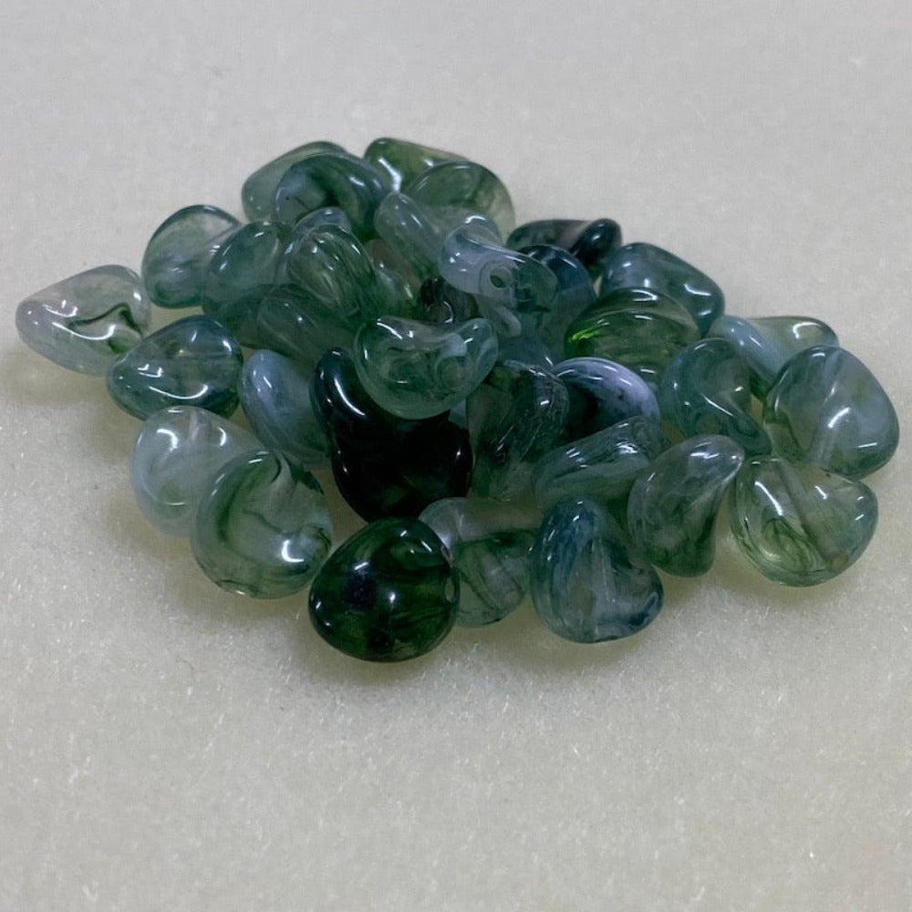 Jade green gemstone style acrylic beads with visible threading holes for crafting jewelry on a white background