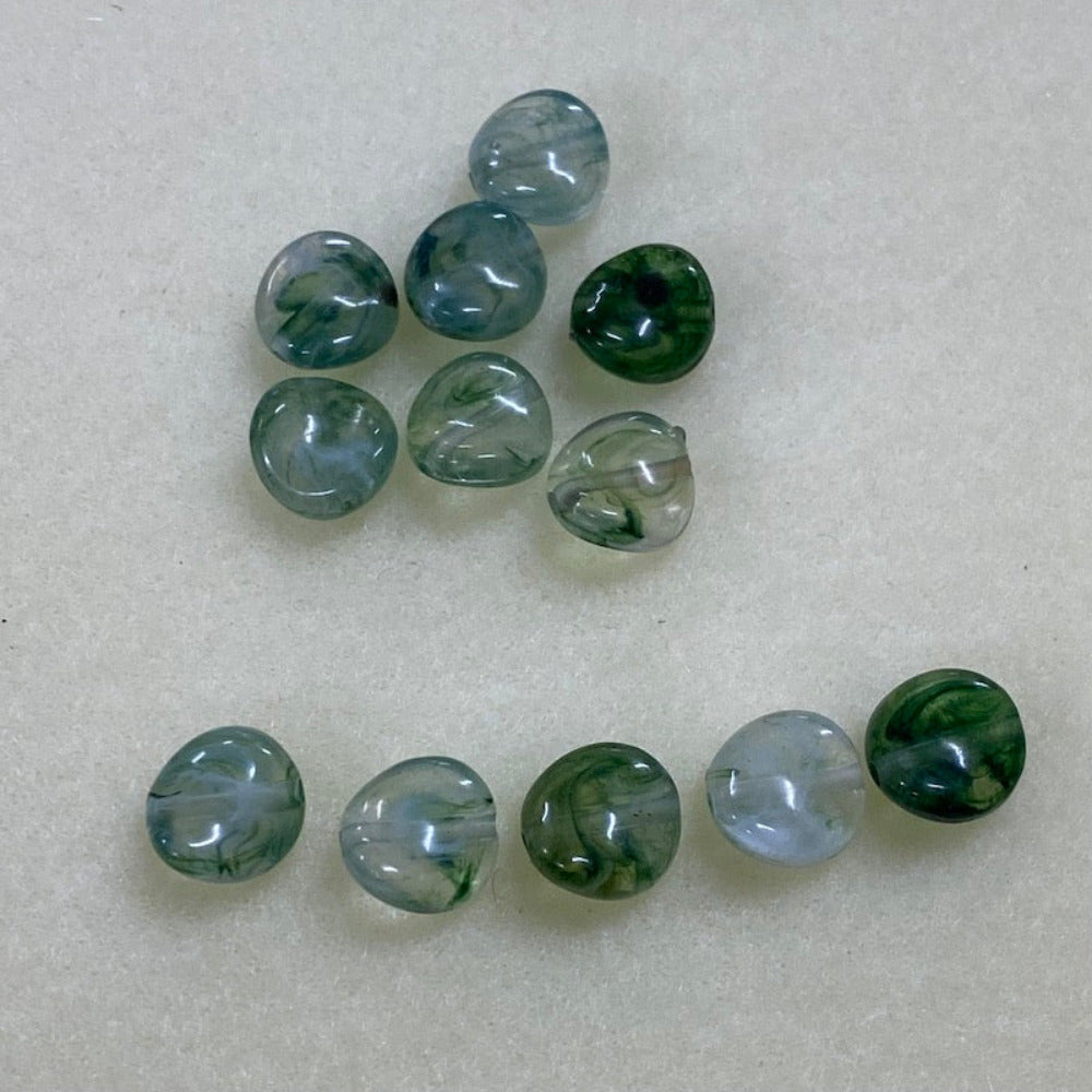 Jade green gemstone style acrylic beads with visible threading holes for crafting jewelry on a white background