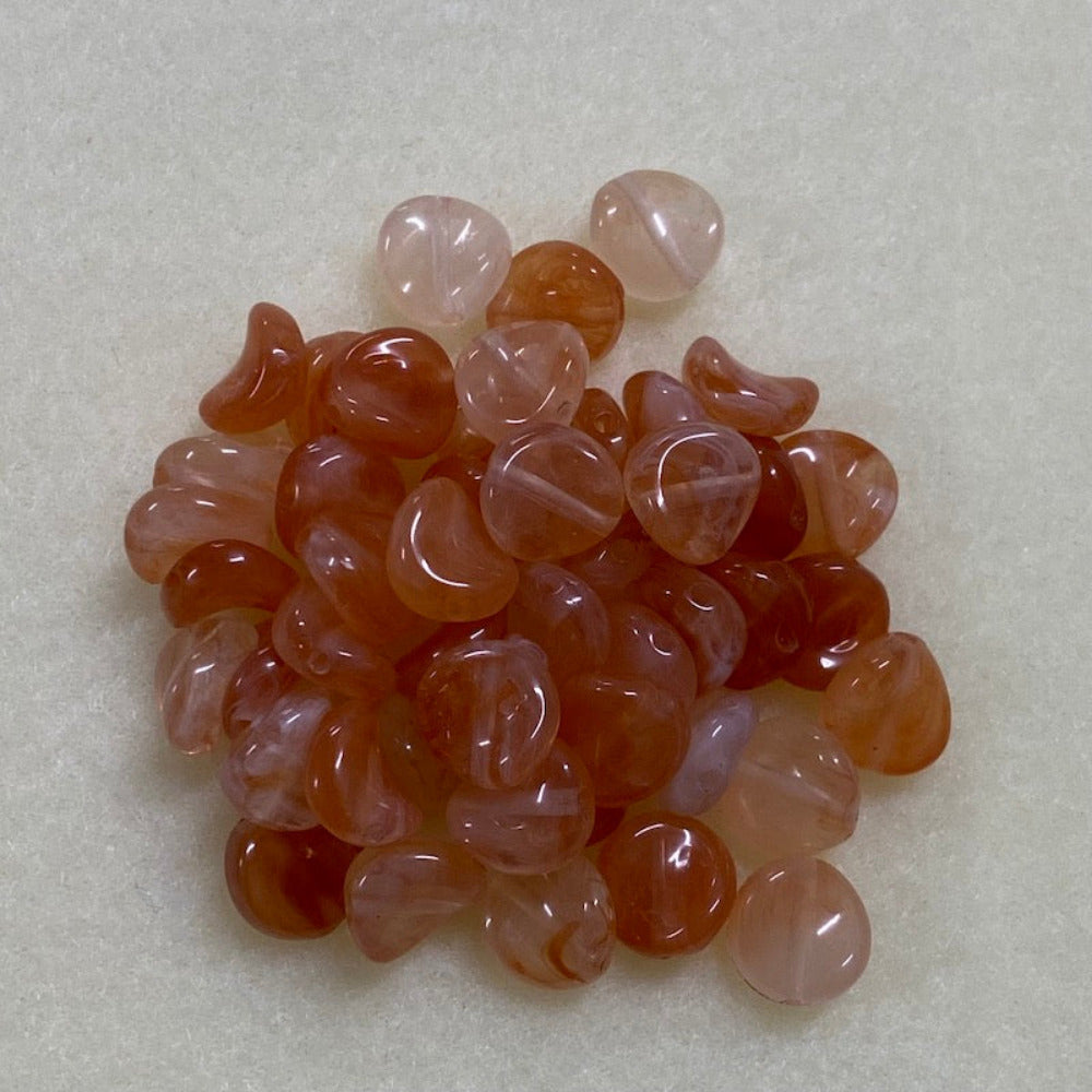 Carnelian orange gemstone style acrylic beads resembling real gemstones, with visible threading holes for crafting jewelry on a white background, used for crafting and jewelry making.