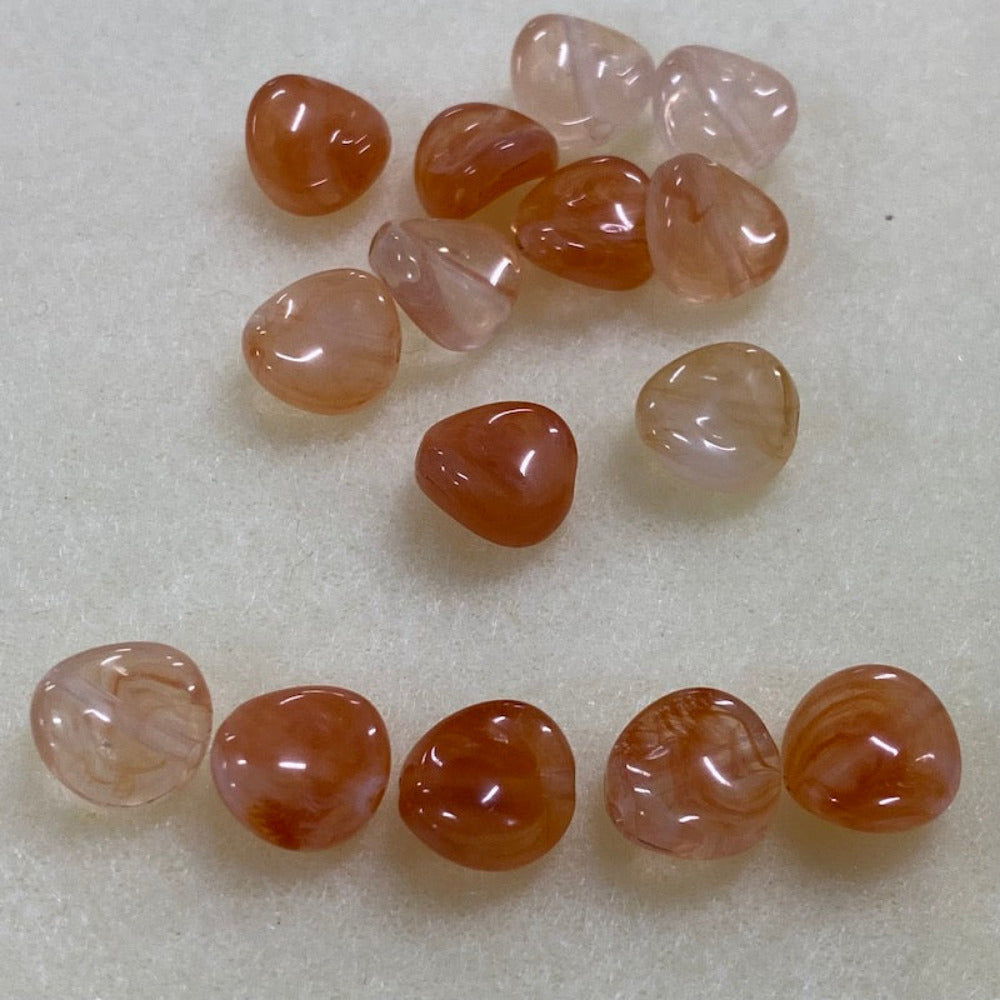 Carnelian orange gemstone style acrylic beads resembling real gemstones, with visible threading holes for crafting jewelry on a white background, used for crafting and jewelry making.