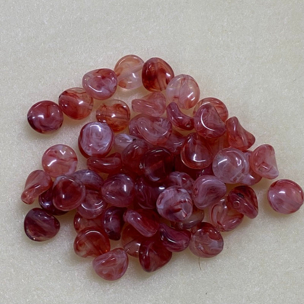 ruby gemstone style acrylic beads with visible threading holes for crafting jewelry on a white background