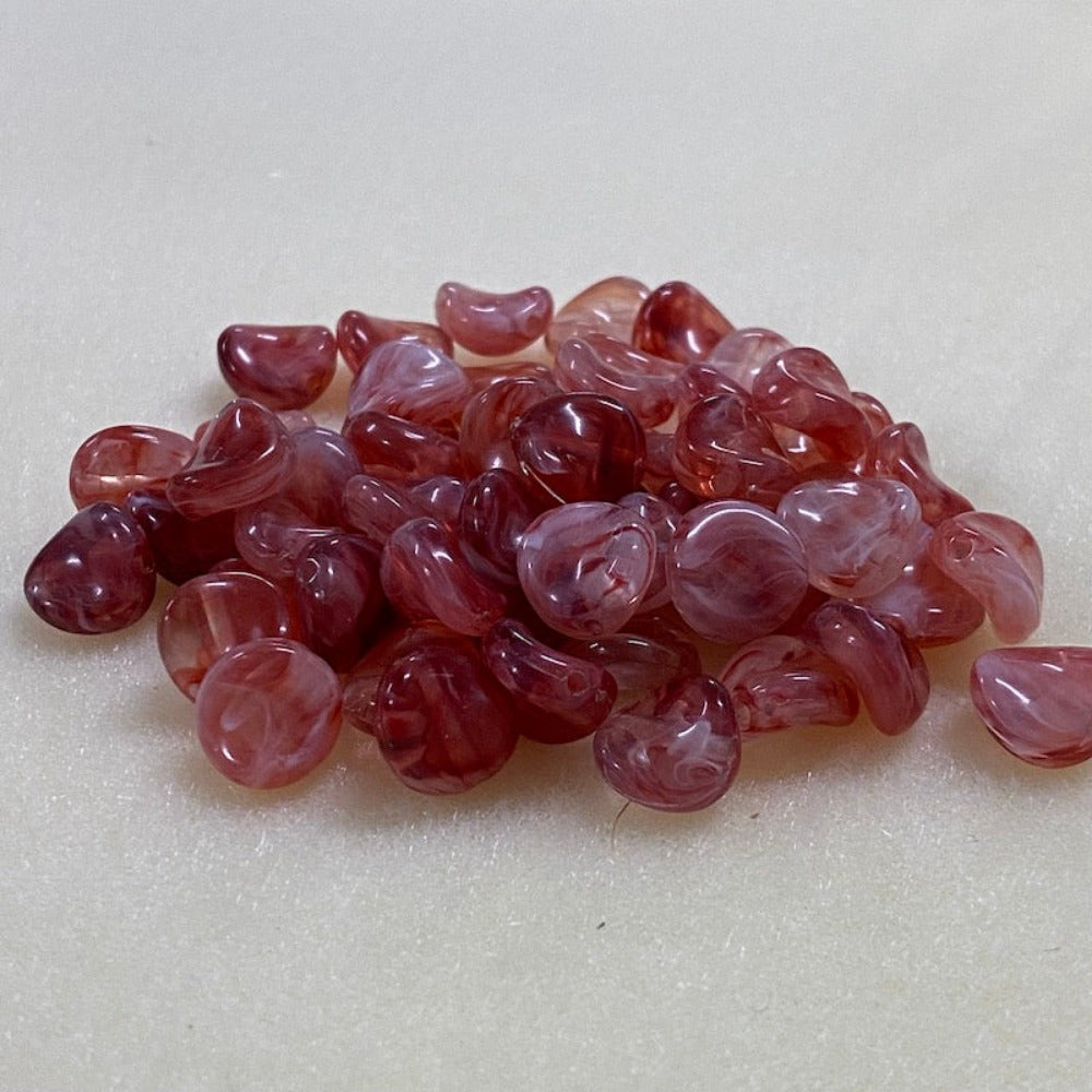 ruby gemstone style acrylic beads with visible threading holes for crafting jewelry on a white background