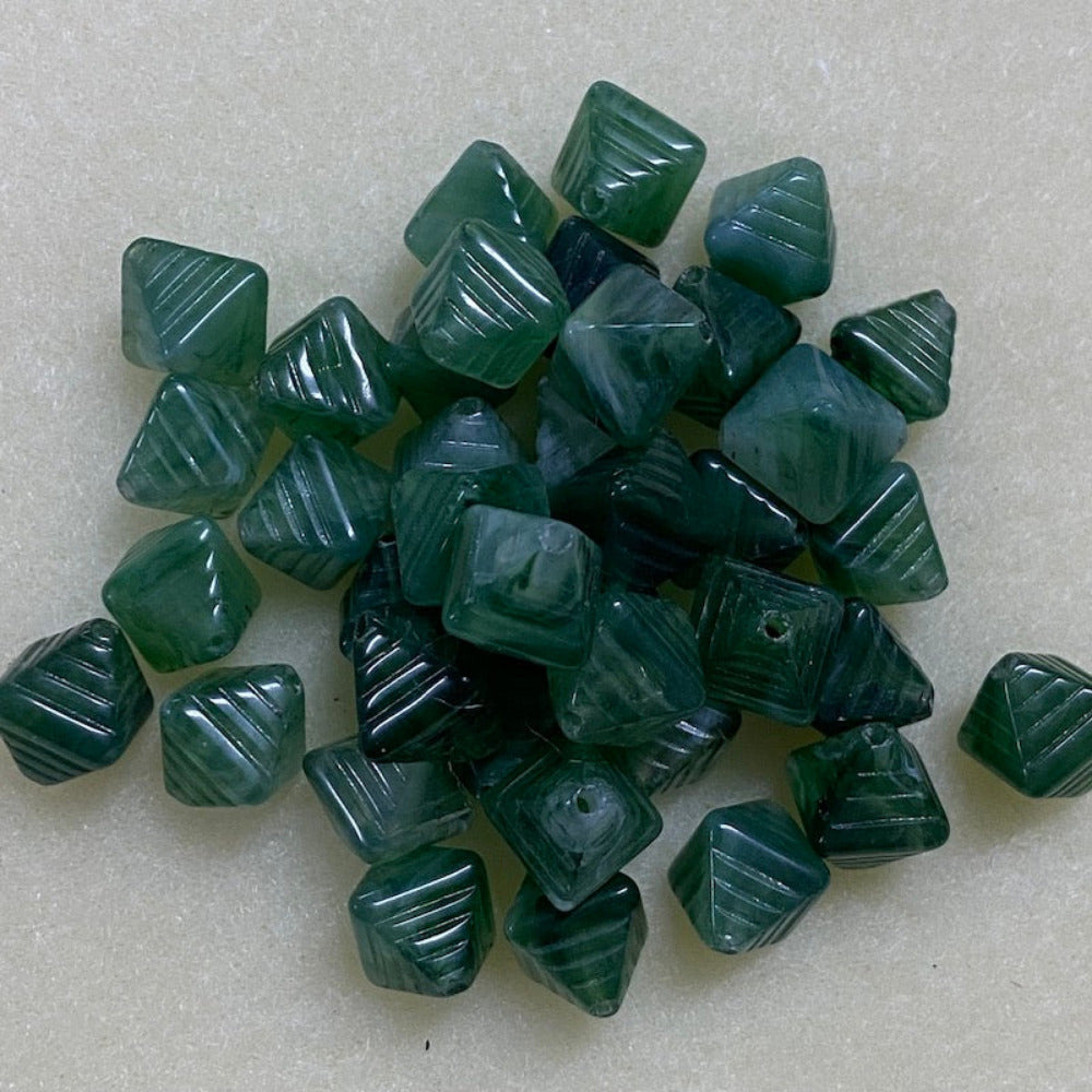 Jade green gemstone style acrylic beads with visible threading holes for crafting jewelry on a white background