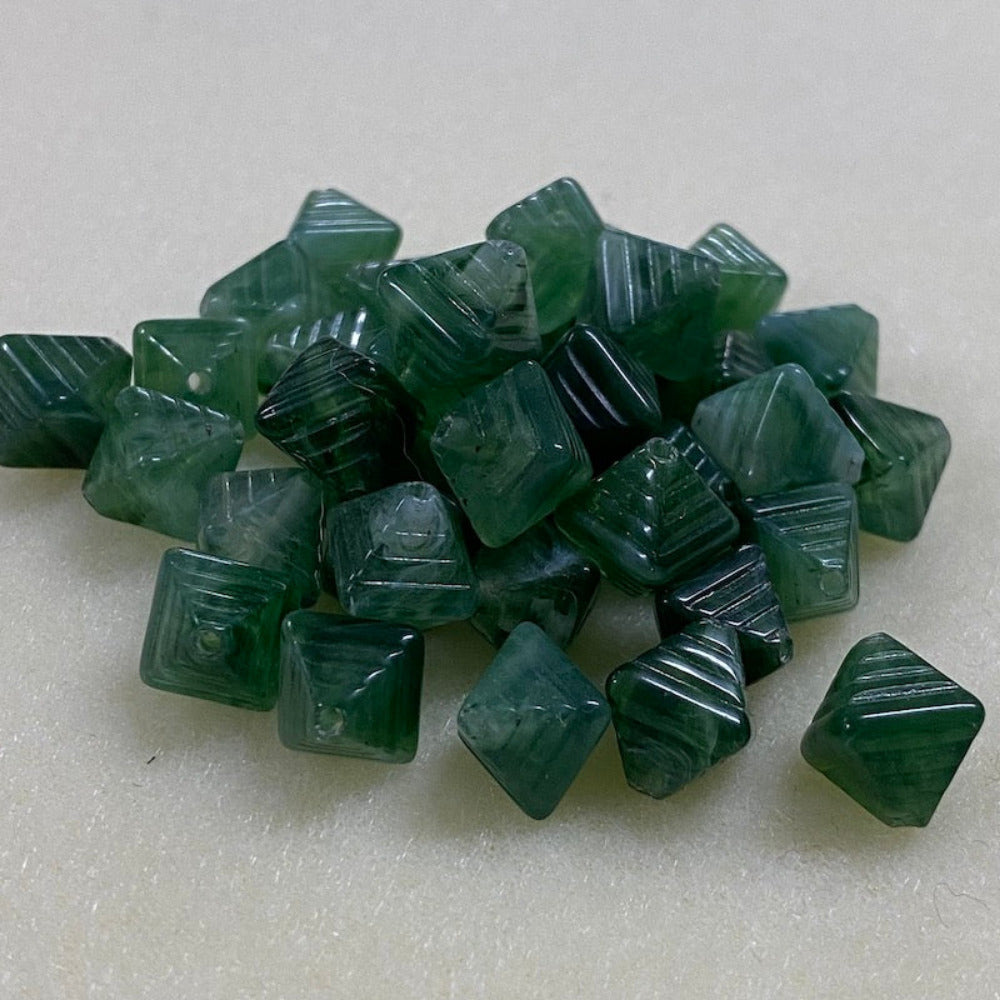 Jade green gemstone style acrylic beads with visible threading holes for crafting jewelry on a white background