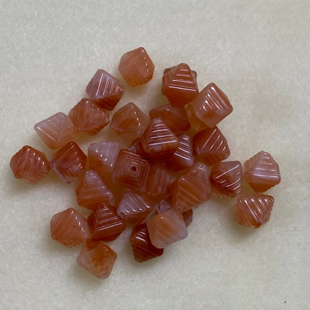 Carnelian orange gemstone style acrylic beads resembling real gemstones, with visible threading holes for crafting jewelry on a white background, used for crafting and jewelry making.