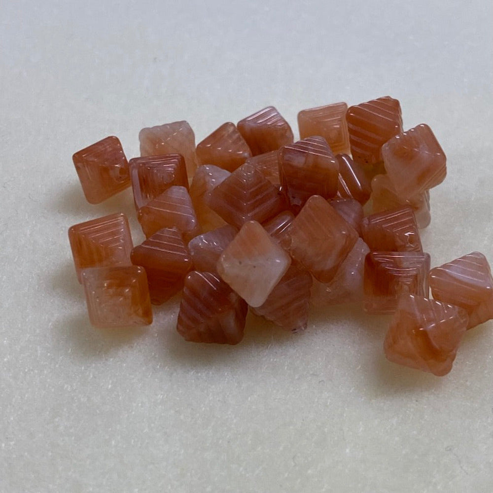 Carnelian orange gemstone style acrylic beads resembling real gemstones, with visible threading holes for crafting jewelry on a white background, used for crafting and jewelry making.