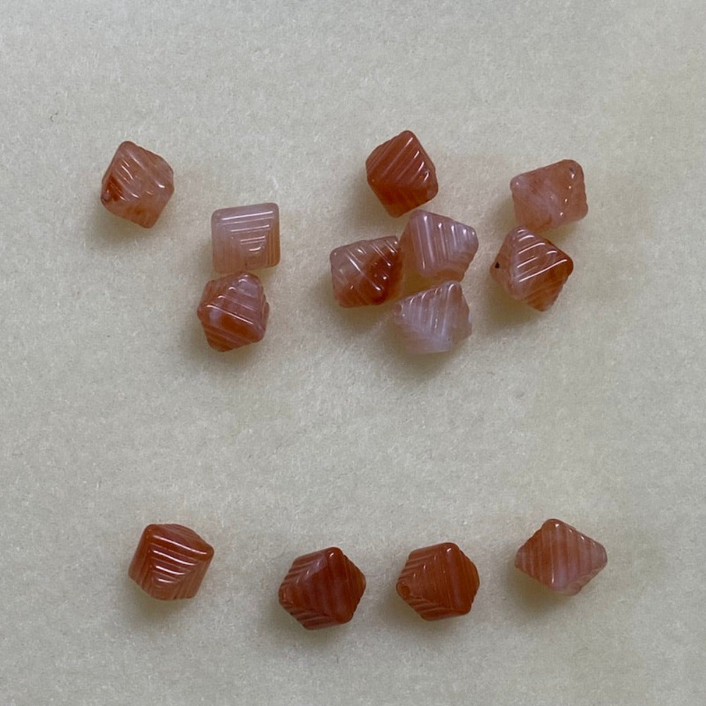 Carnelian orange gemstone style acrylic beads resembling real gemstones, with visible threading holes for crafting jewelry on a white background, used for crafting and jewelry making.