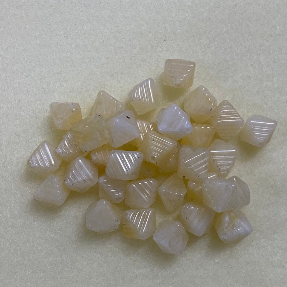Citrine yellow gemstone style acrylic beads with visible threading holes for crafting jewelry on a white background