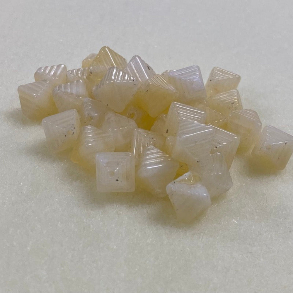 Citrine yellow gemstone style acrylic beads with visible threading holes for crafting jewelry on a white background