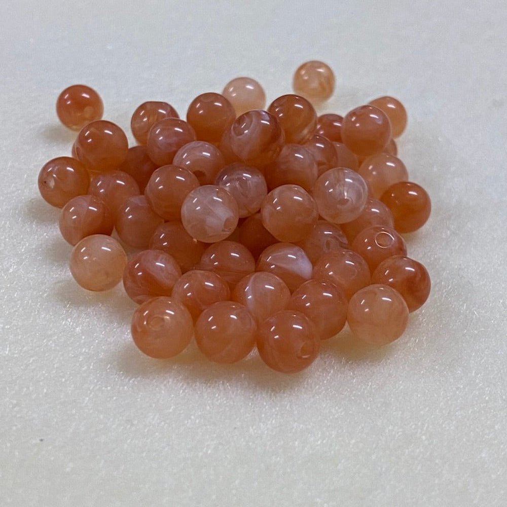 Carnelian orange gemstone style acrylic beads resembling real gemstones, with visible threading holes for crafting jewelry on a white background, used for crafting and jewelry making.