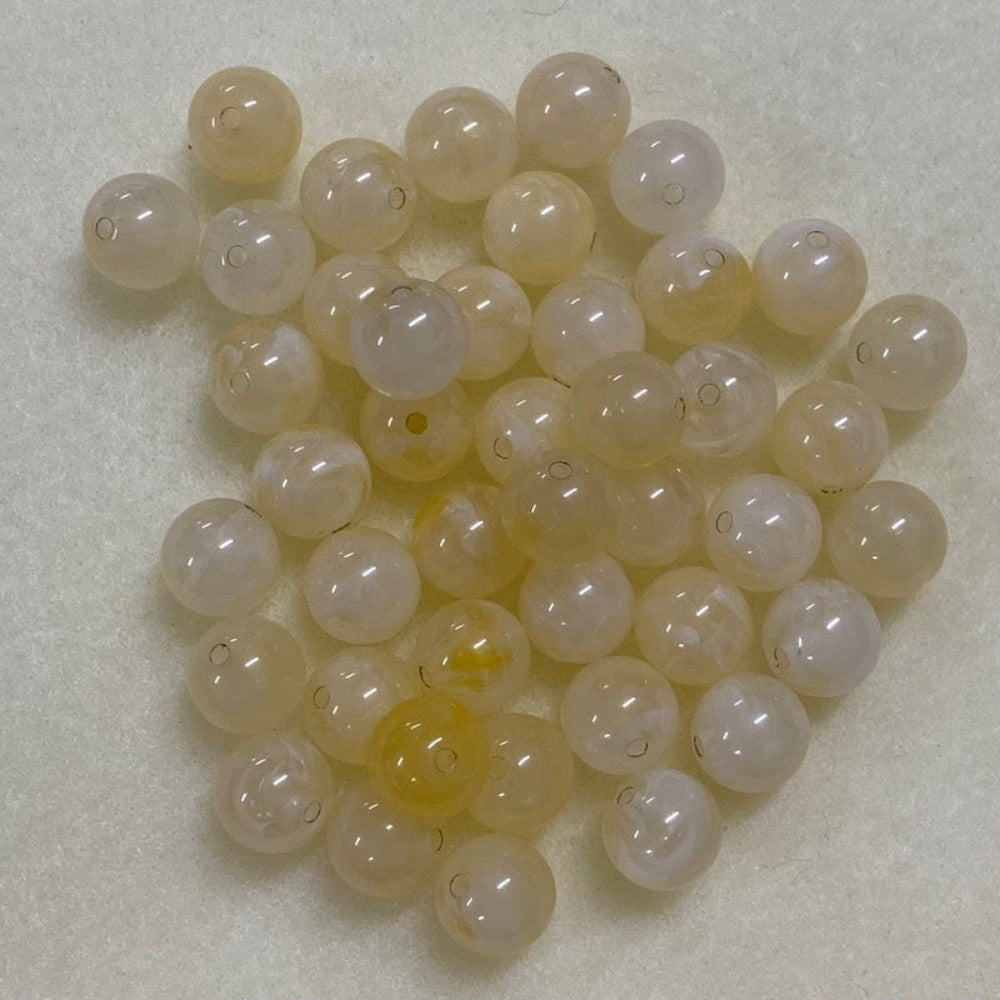 Citrine yellow gemstone style acrylic beads resembling real gemstones, with visible threading holes for crafting jewelry on a white background, used for crafting and jewelry making.