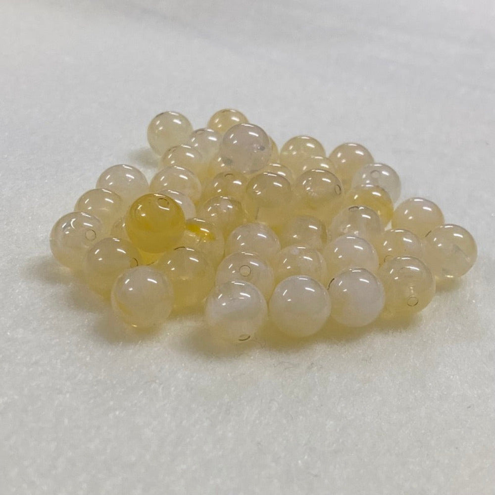 Citrine yellow gemstone style acrylic beads resembling real gemstones, with visible threading holes for crafting jewelry on a white background, used for crafting and jewelry making.