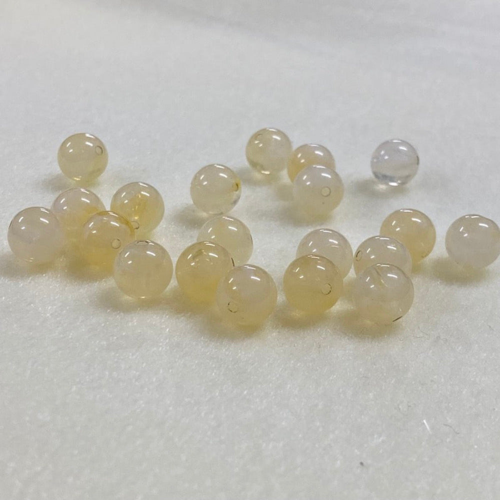 Citrine yellow gemstone style acrylic beads resembling real gemstones, with visible threading holes for crafting jewelry on a white background, used for crafting and jewelry making.