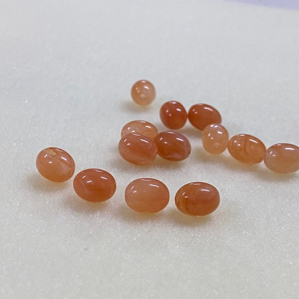 carnelian gemstone style acrylic beads resembling real gemstones, with visible threading holes for crafting jewelry on a white background, used for crafting and jewelry