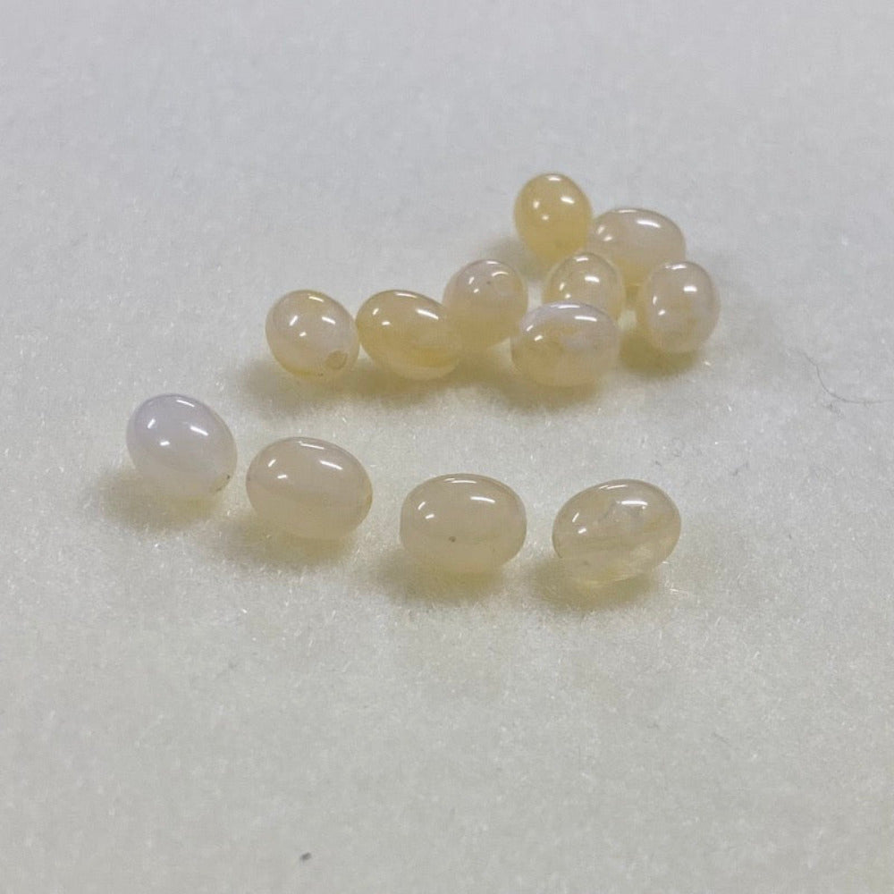 Citrine yellow gemstone style acrylic beads resembling real gemstones, with visible threading holes for crafting jewelry on a white background, used for crafting and jewelry making.