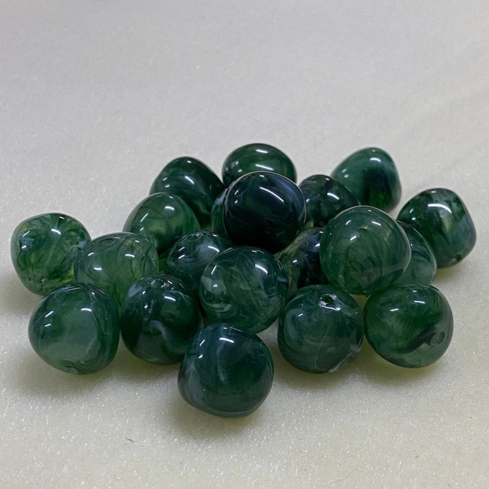 Jade green gemstone style acrylic beads with visible threading holes for crafting jewelry on a white background