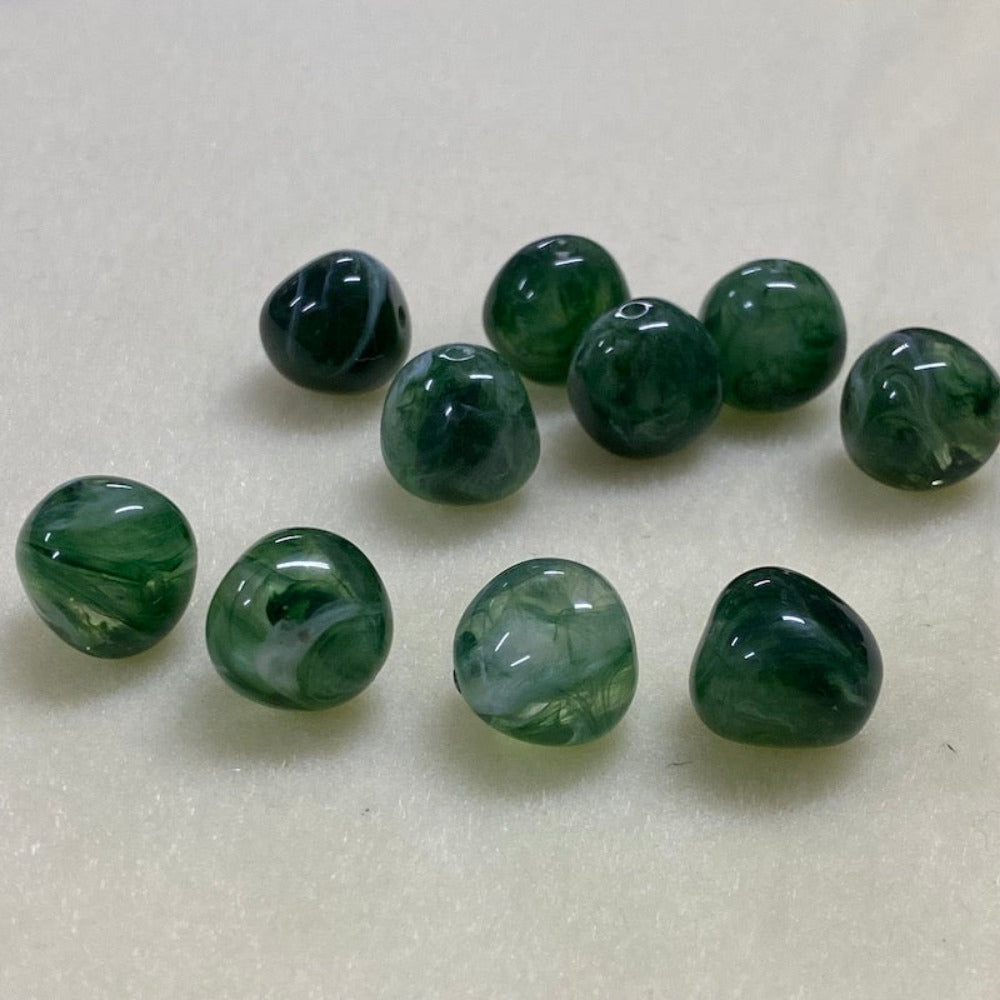 Jade green gemstone style acrylic beads with visible threading holes for crafting jewelry on a white background