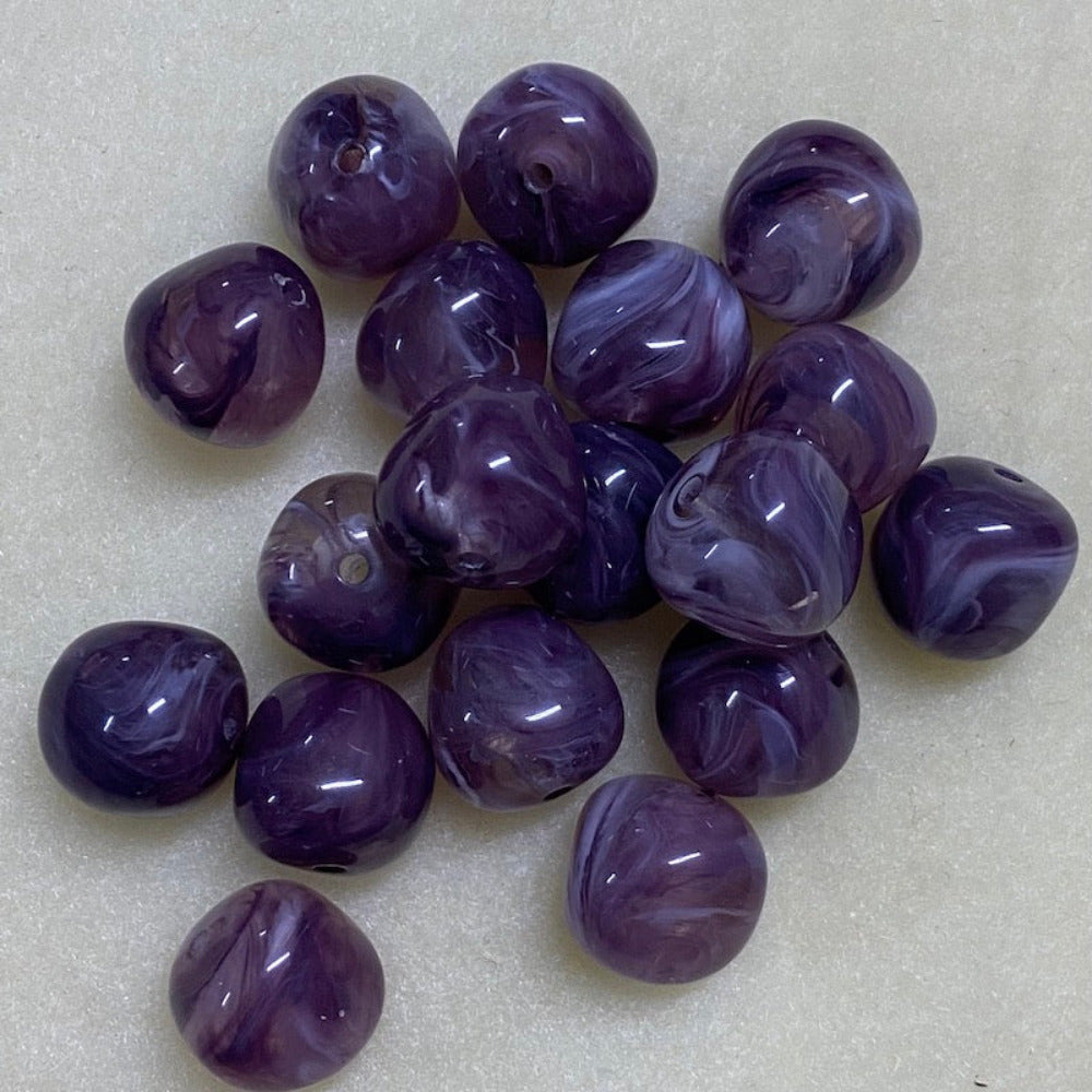 Amethyst purple gemstone style acrylic beads resembling real gemstones, with visible threading holes for crafting jewelry on a white background, used for crafting and jewelry making.