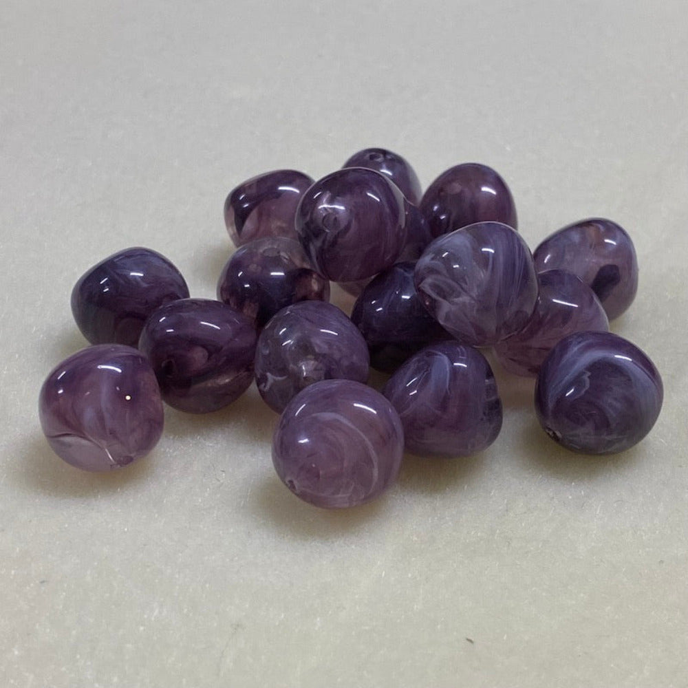 Amethyst purple gemstone style acrylic beads resembling real gemstones, with visible threading holes for crafting jewelry on a white background, used for crafting and jewelry making.