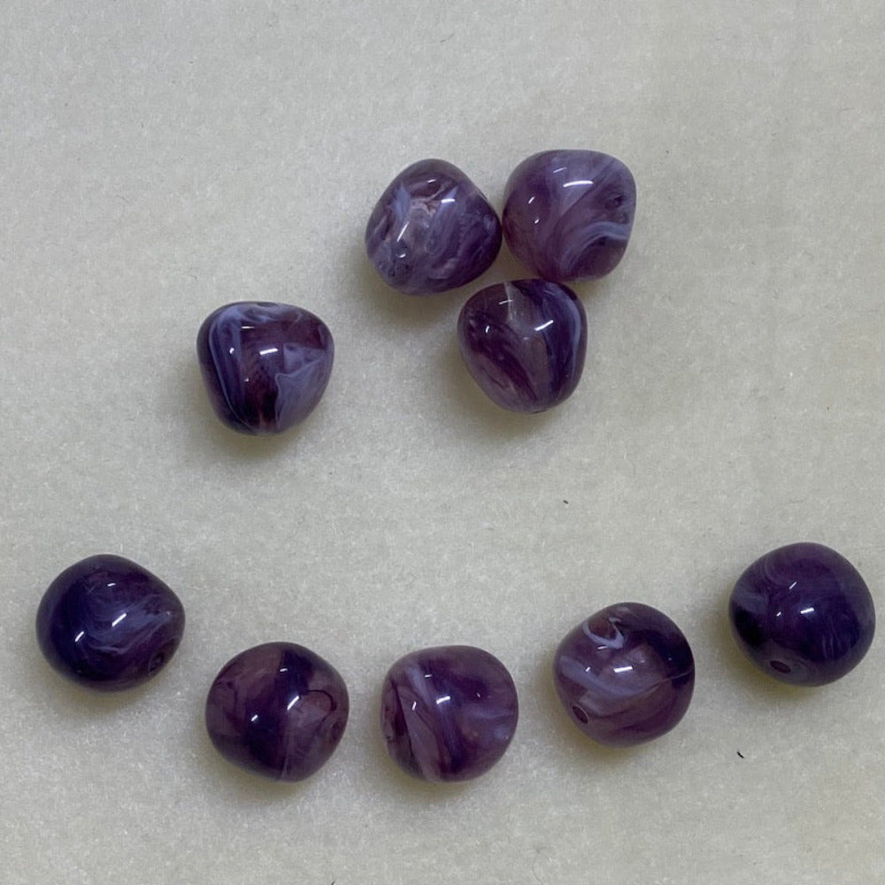 Amethyst purple gemstone style acrylic beads resembling real gemstones, with visible threading holes for crafting jewelry on a white background, used for crafting and jewelry making.