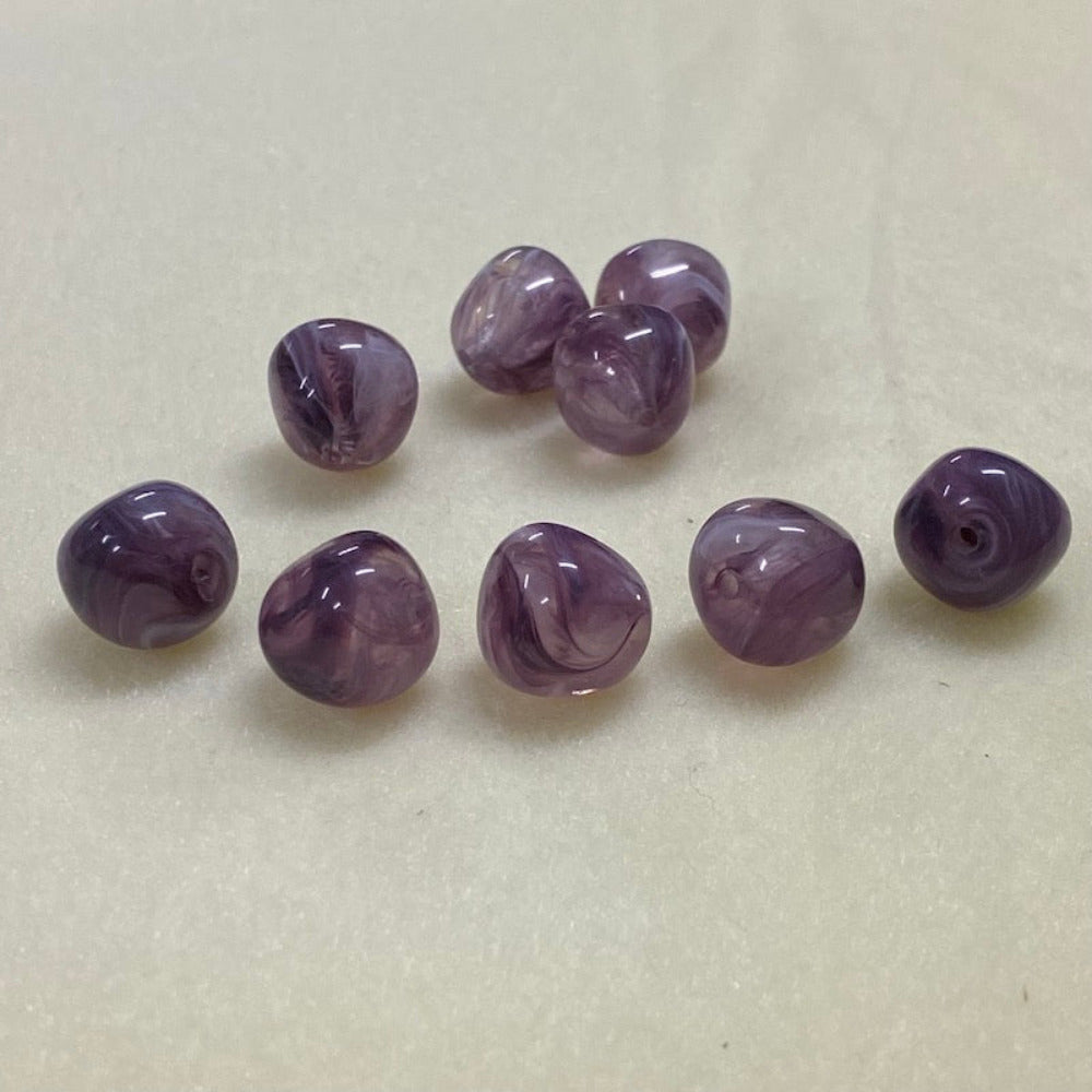 Amethyst purple gemstone style acrylic beads resembling real gemstones, with visible threading holes for crafting jewelry on a white background, used for crafting and jewelry making.