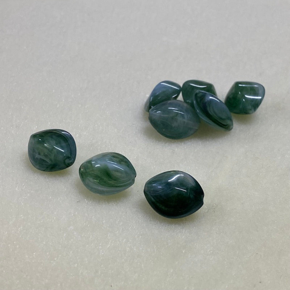 Jade green gemstone style acrylic beads with visible threading holes for crafting jewelry on a white background