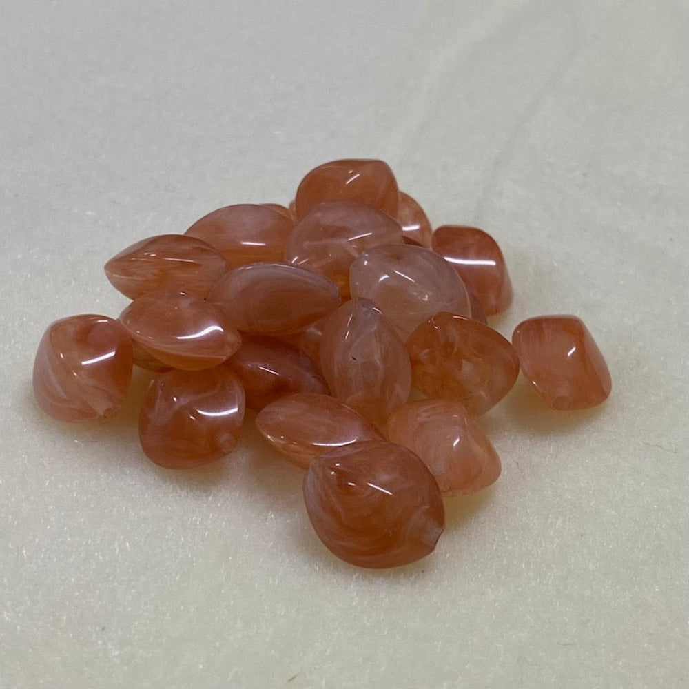 Carnelian orange gemstone style acrylic beads resembling real gemstones, with visible threading holes for crafting jewelry on a white background, used for crafting and jewelry making.