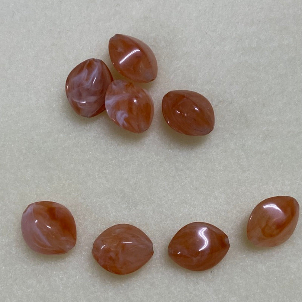 Carnelian orange gemstone style acrylic beads resembling real gemstones, with visible threading holes for crafting jewelry on a white background, used for crafting and jewelry making.