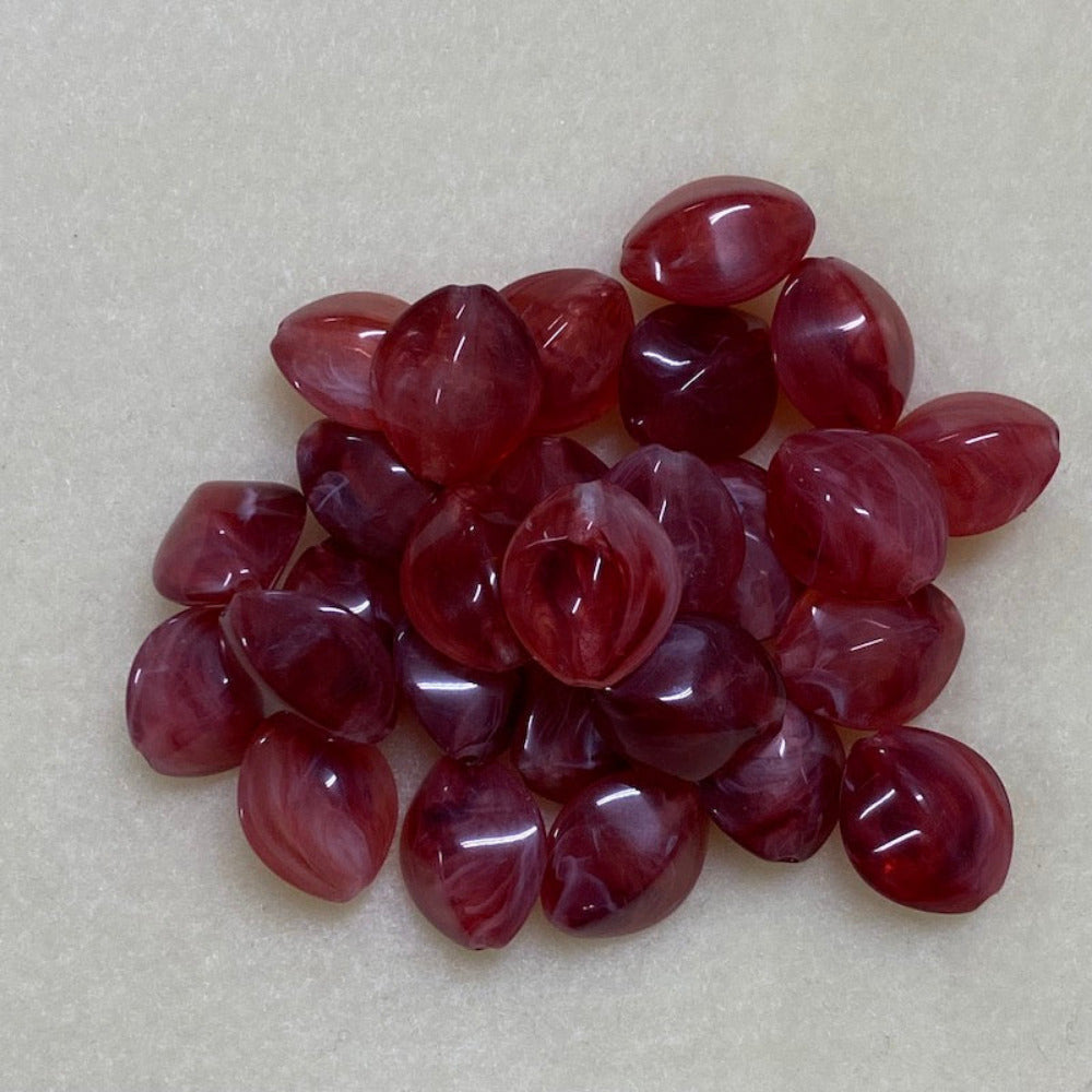 ruby look acrylic beads with visible threading holes for crafting jewelry on a white background