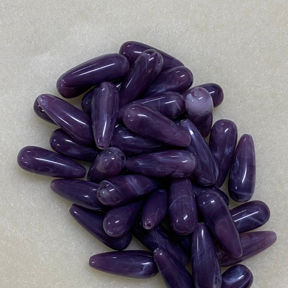 Amethyst purple gemstone style acrylic beads resembling real gemstones, with visible threading holes for crafting jewelry on a white background, used for crafting and jewelry making.