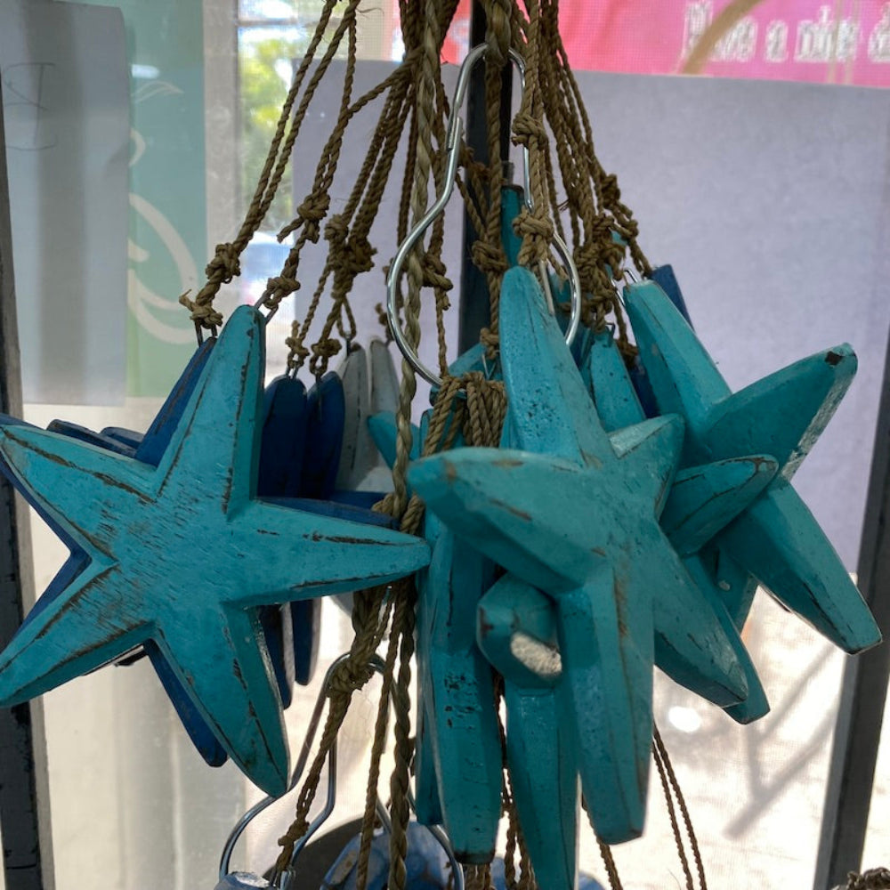 Wood star decorations in a shop window strung on seagrass string