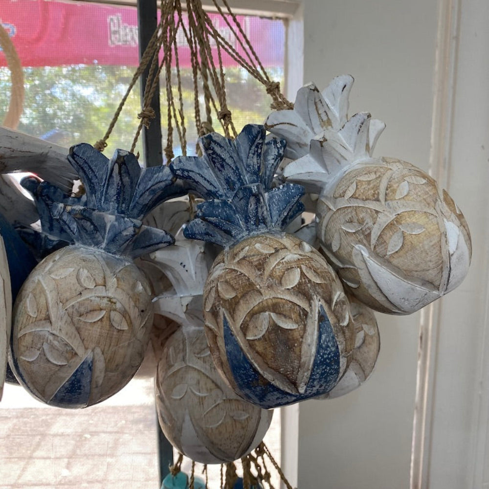 Wood blue and white pineapple decorations in a shop window