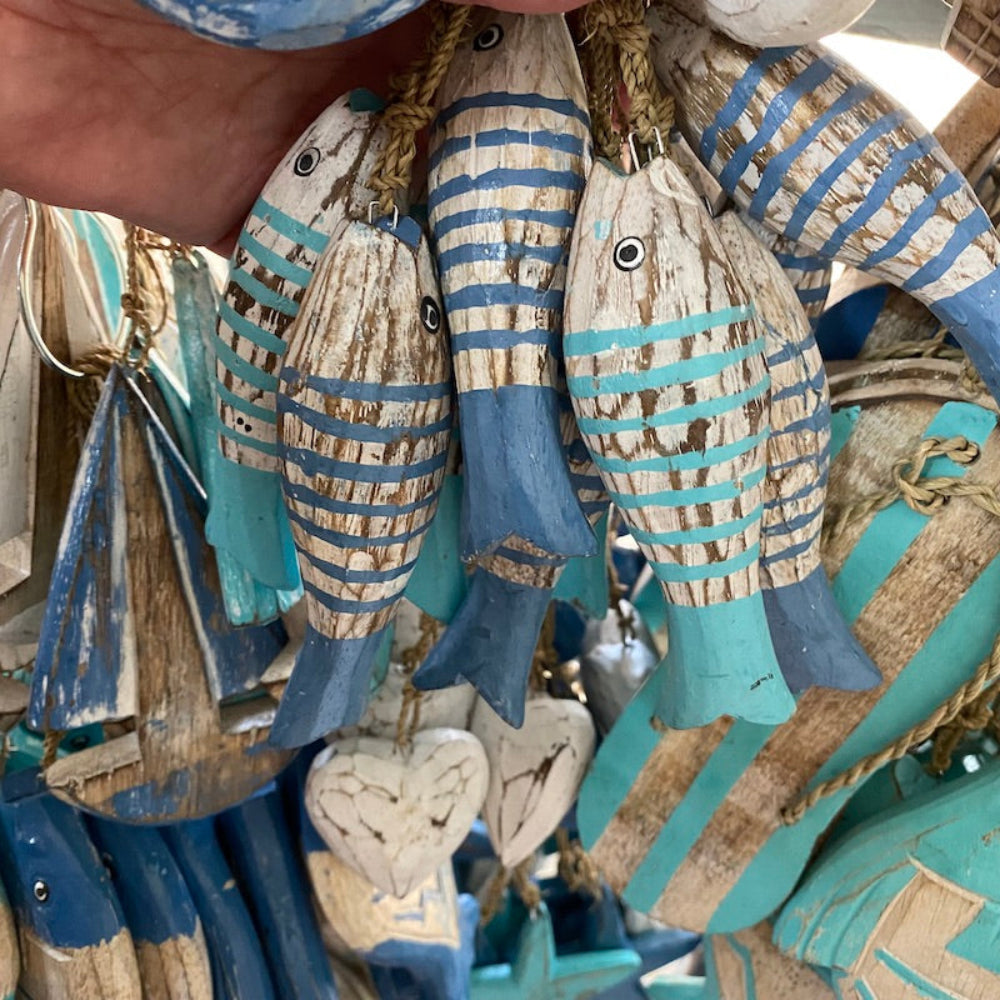 Wood white fish decorations with other wood shapes in the background