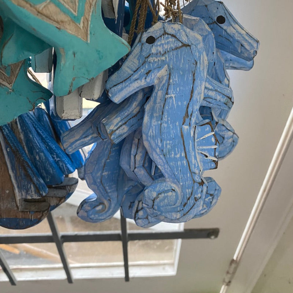 Wood blue purple colour seahorse decorations in a shop window