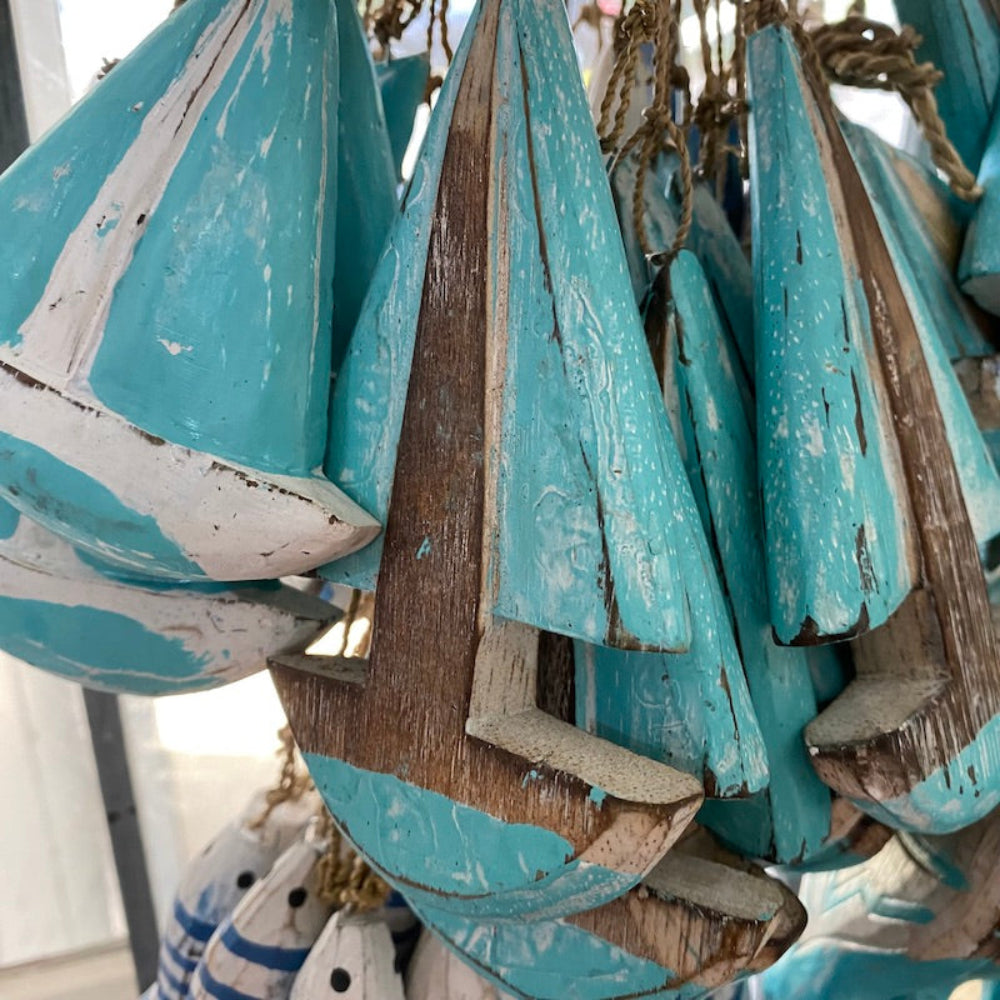 Wood light blue turquoise and white sailing yacht boat decorations in a shop window