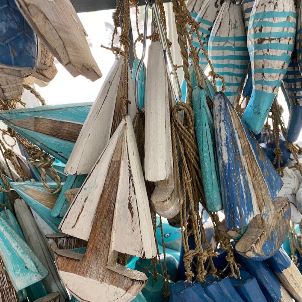 Wood light blue turquoise and white sailing yacht boat decorations in a shop window