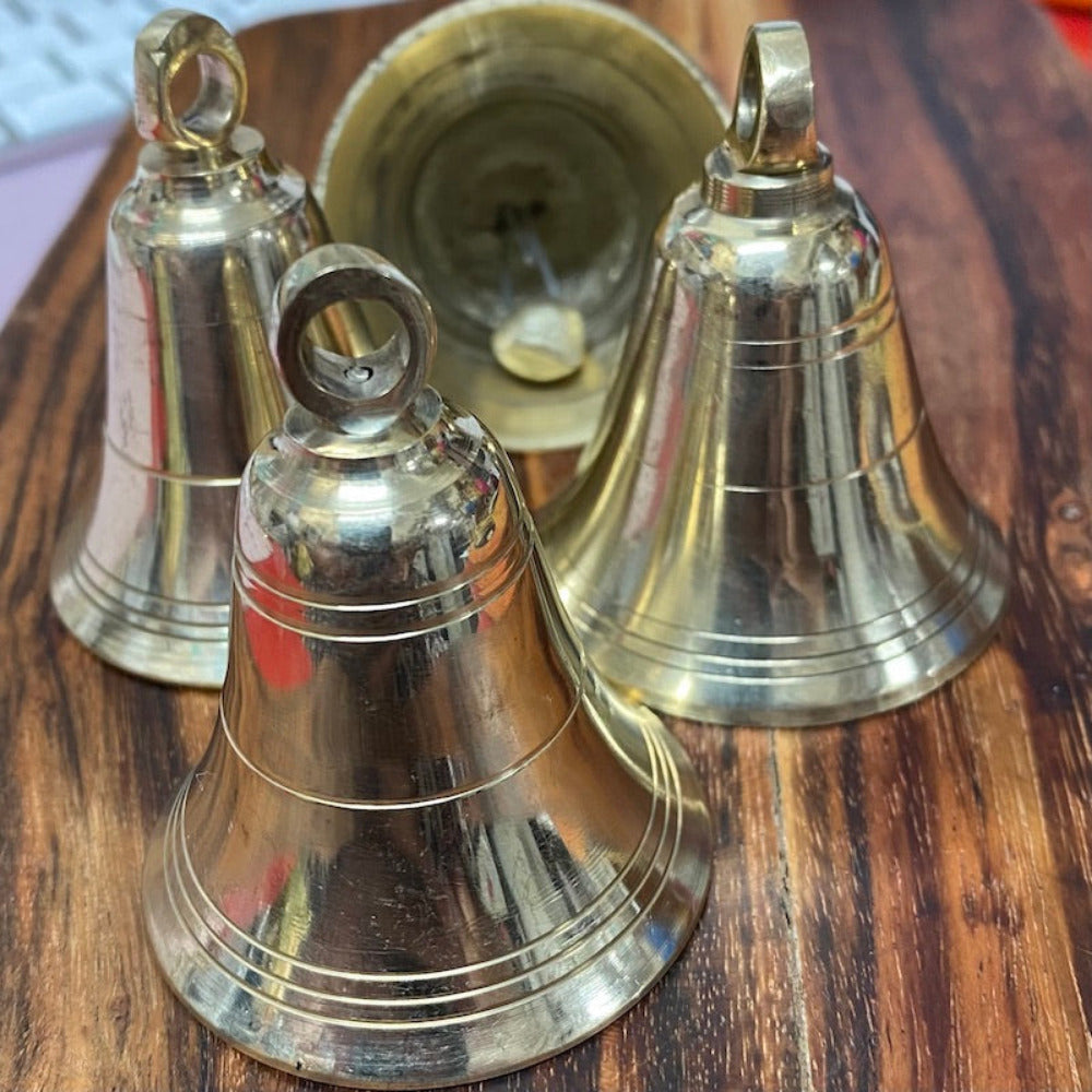 handmade brass bell on a wooden surface for the purpose of decoration and craft