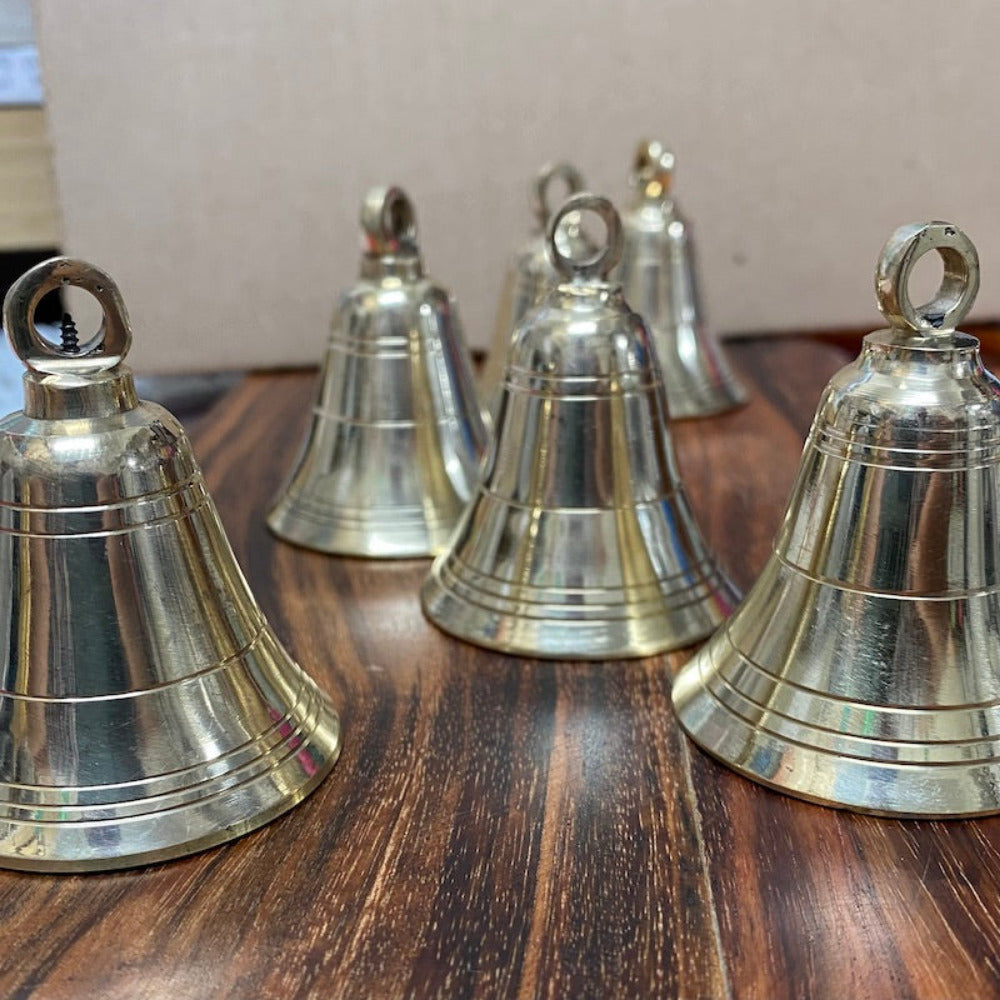 handmade brass bell on a wooden surface for the purpose of decoration and craft