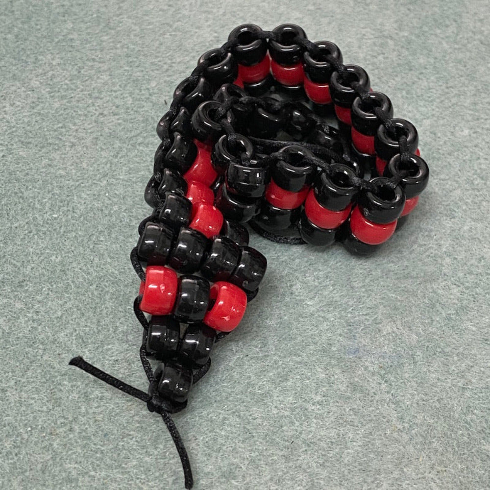 red belly black snake beaded toy made at Bead Shack snakes & lizard birthday party on a grey background