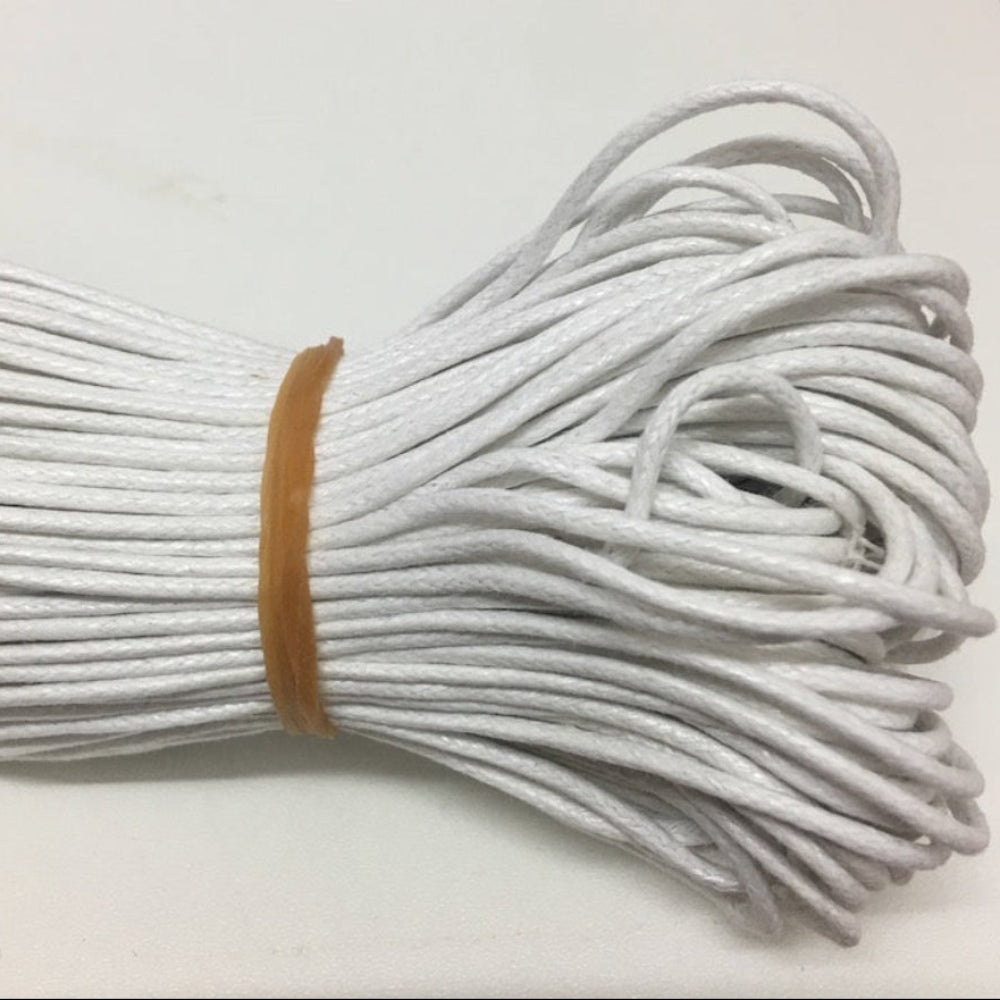 A bundle of thick white wax cotton cord used for crafting and jewelry making.