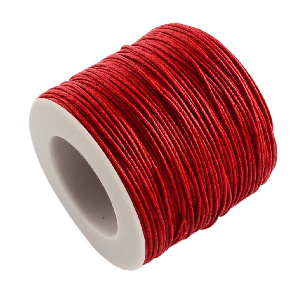 A spool of red wax cotton cord used for crafting and jewelry making.