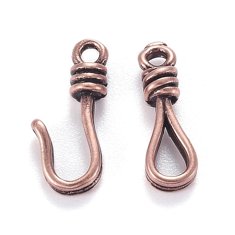 Two hook and eye clasps in an ancient brass color on a white background.